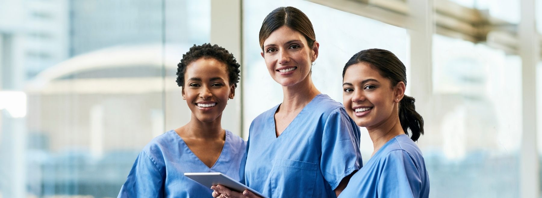 Three smiling female nurses